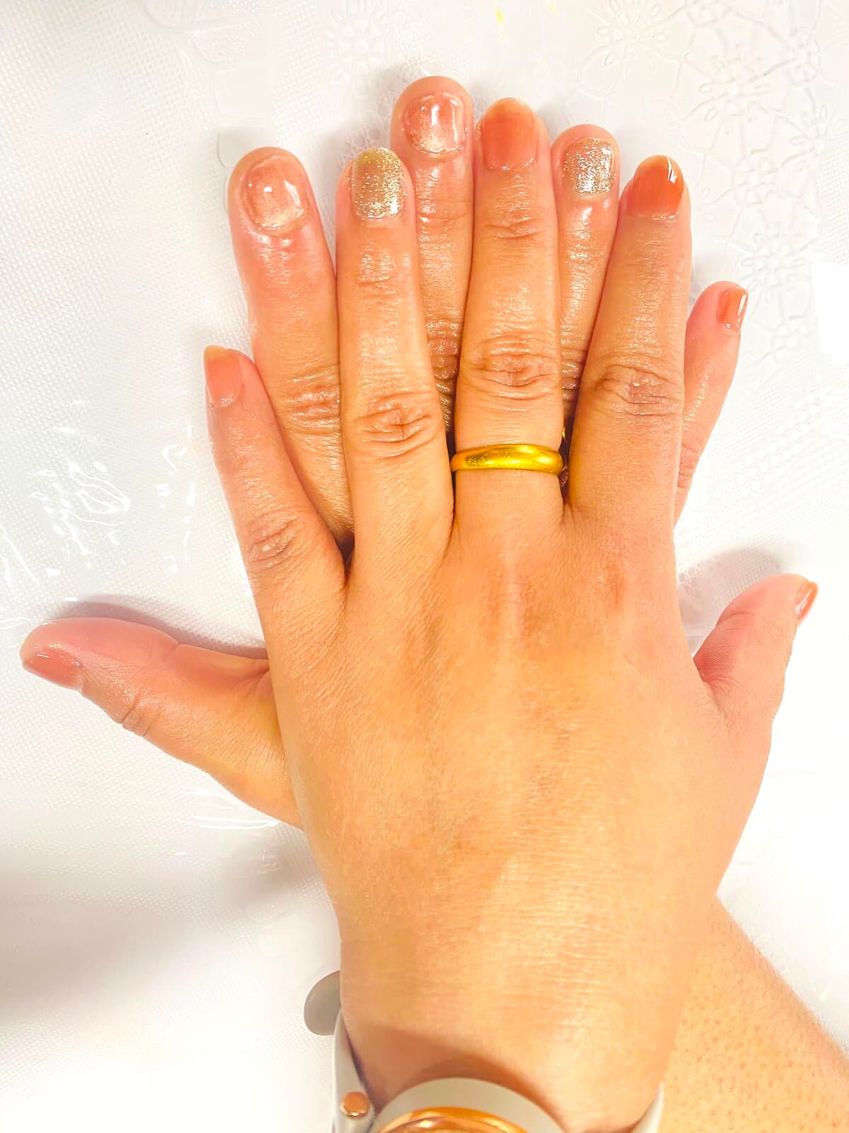Neutral gel manicure with gold glitter accents